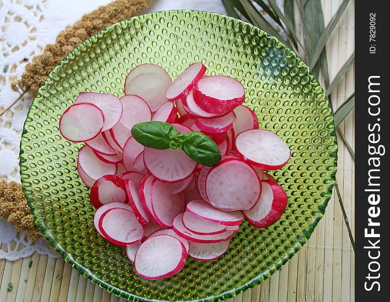 A fresh salad of red radish with basil