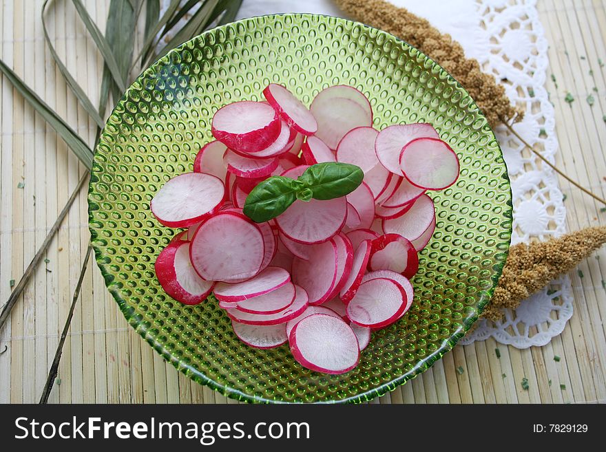 A fresh salad of red radish with basil
