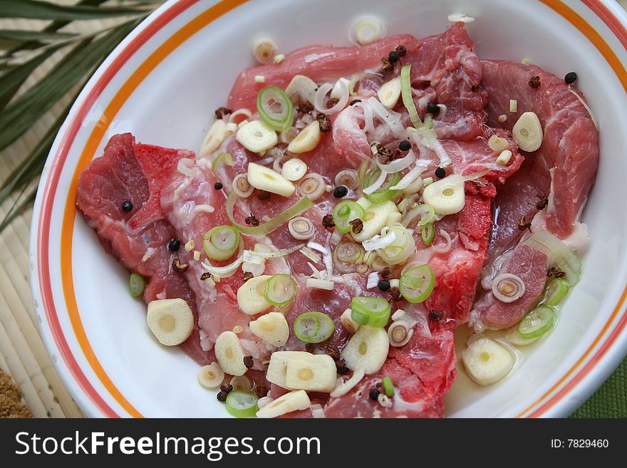 Fresh meat of pork with spring onions and pepper