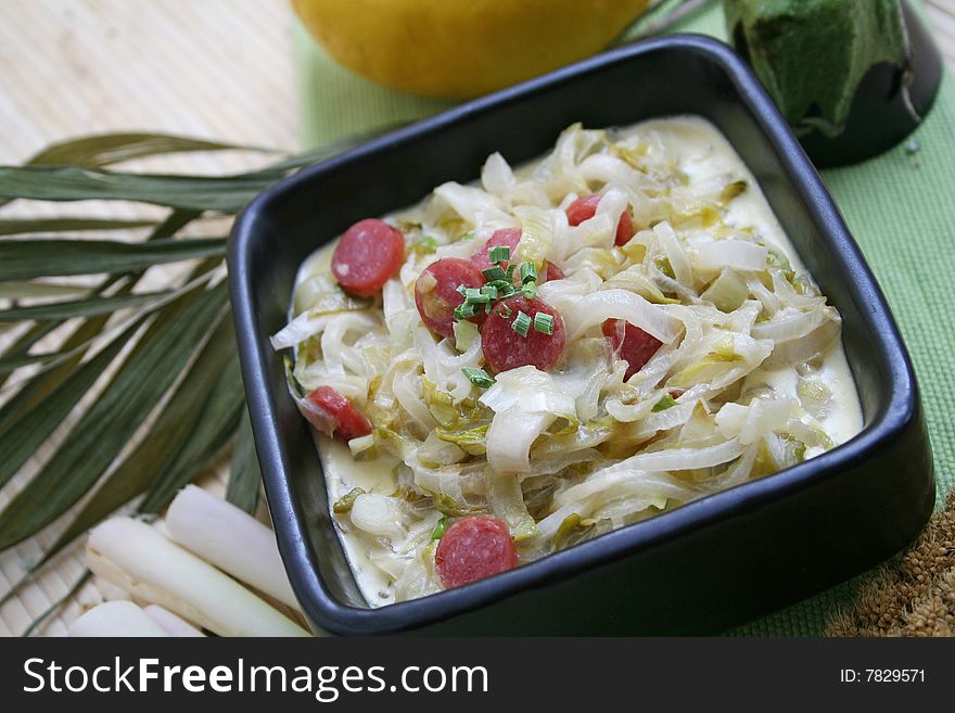 A fresh stew of endive with some sausage