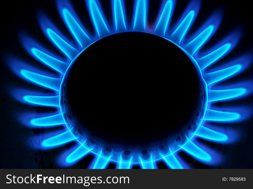 Blue flames of gas stove in the dark