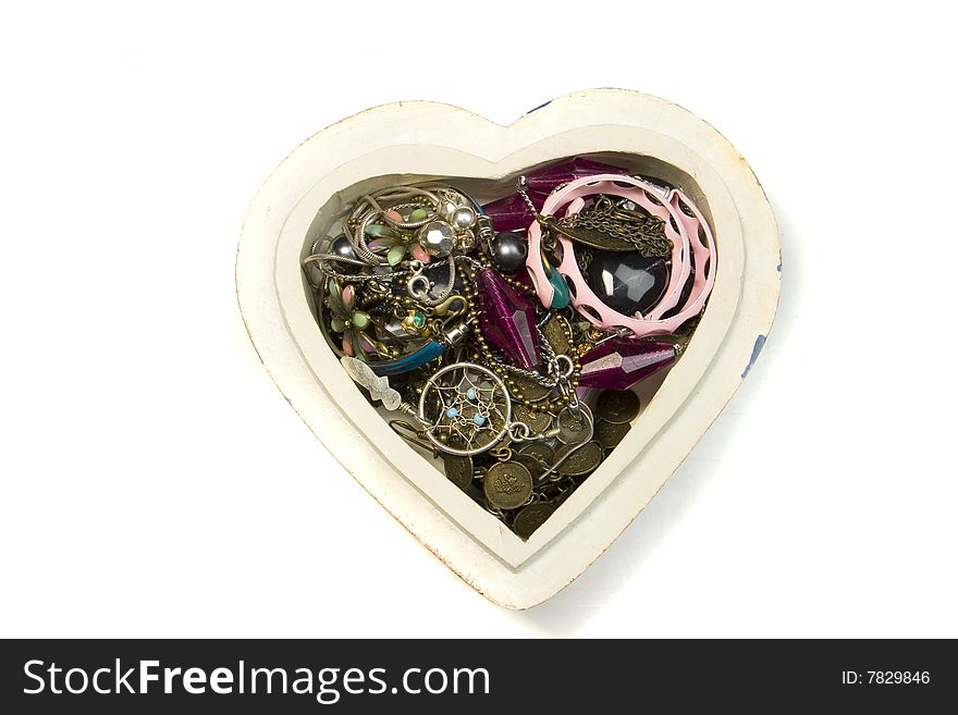 Heart box with jewelry on white ground