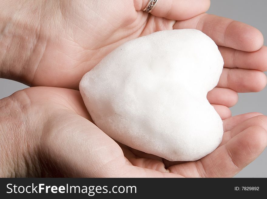 Snow heart in human hands