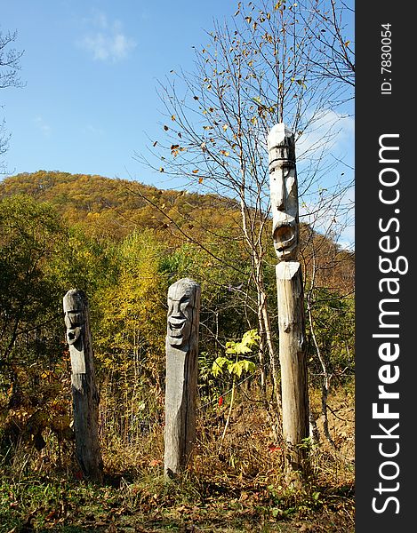 Idols protectors aboriginal on background autumn wood