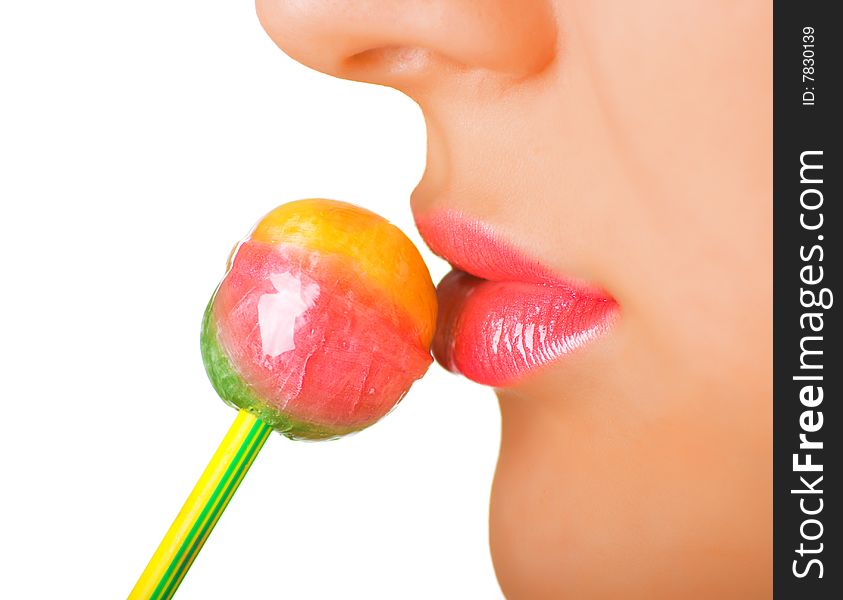 A women with the brightly painted lips eating a lollipop candy. Shallow DOF. A women with the brightly painted lips eating a lollipop candy. Shallow DOF.