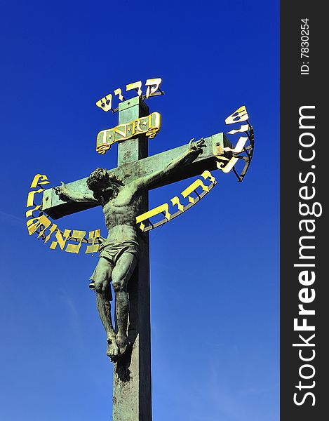 Prague Charles Bridge crucifixion Jesus blue sky Europe Czech Republic