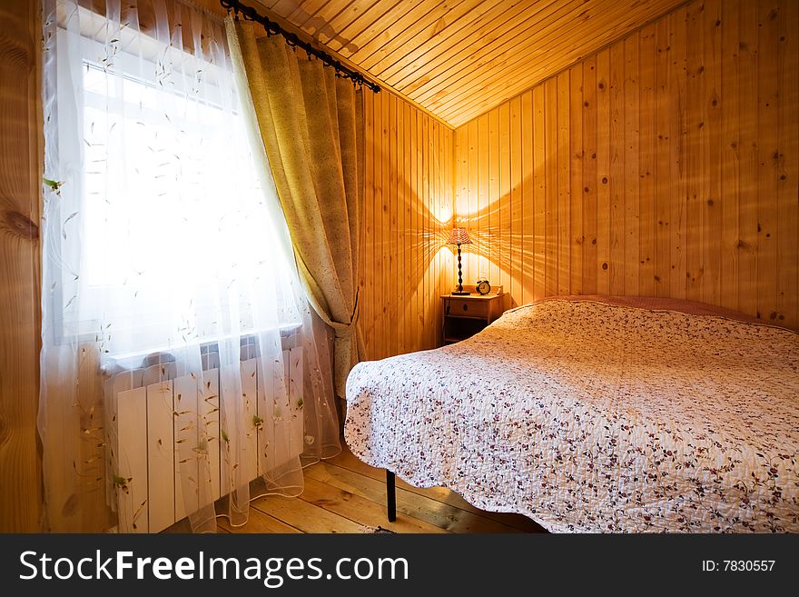 Cosy and wooden bedroom in modern hotel