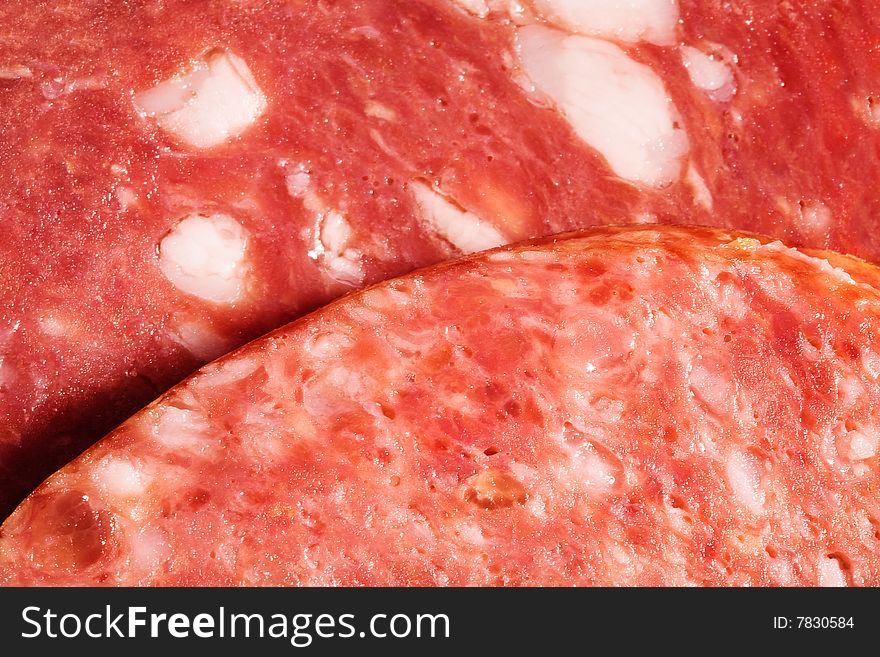 Slices of sausage close up as a background