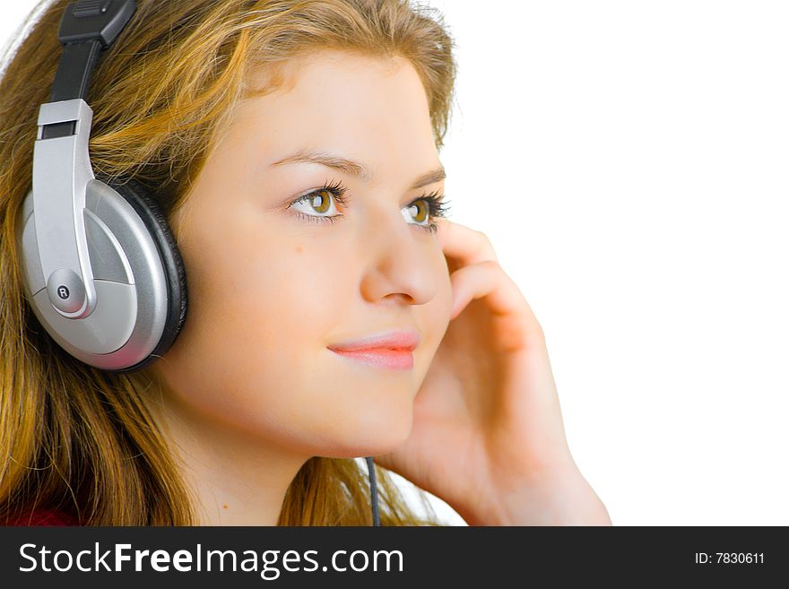 Beautiful young girl listens to music with headphones. Beautiful young girl listens to music with headphones