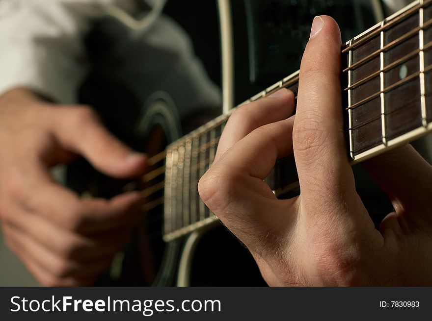 Musician playing on black acoustic guitar. Musician playing on black acoustic guitar