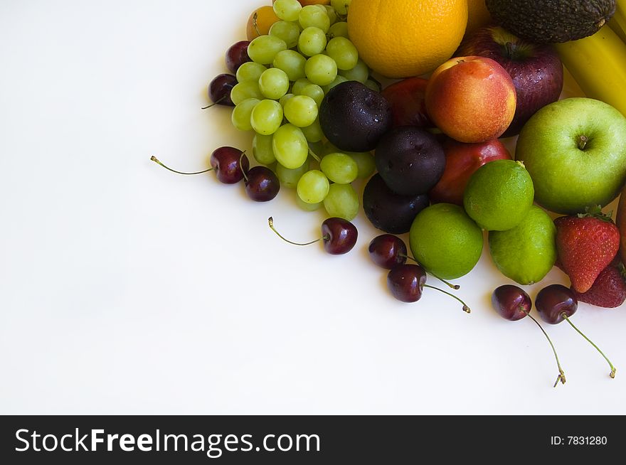 Fresh tropical fruit layed out on a white background