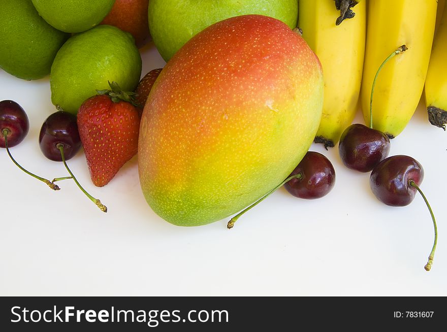 Fresh tropical fruit layed out on a white background