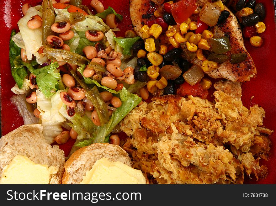 Lettuce, black-eyed peas, and green beans next to Santa Fe style chicken and yellow squash casserole. Lettuce, black-eyed peas, and green beans next to Santa Fe style chicken and yellow squash casserole.