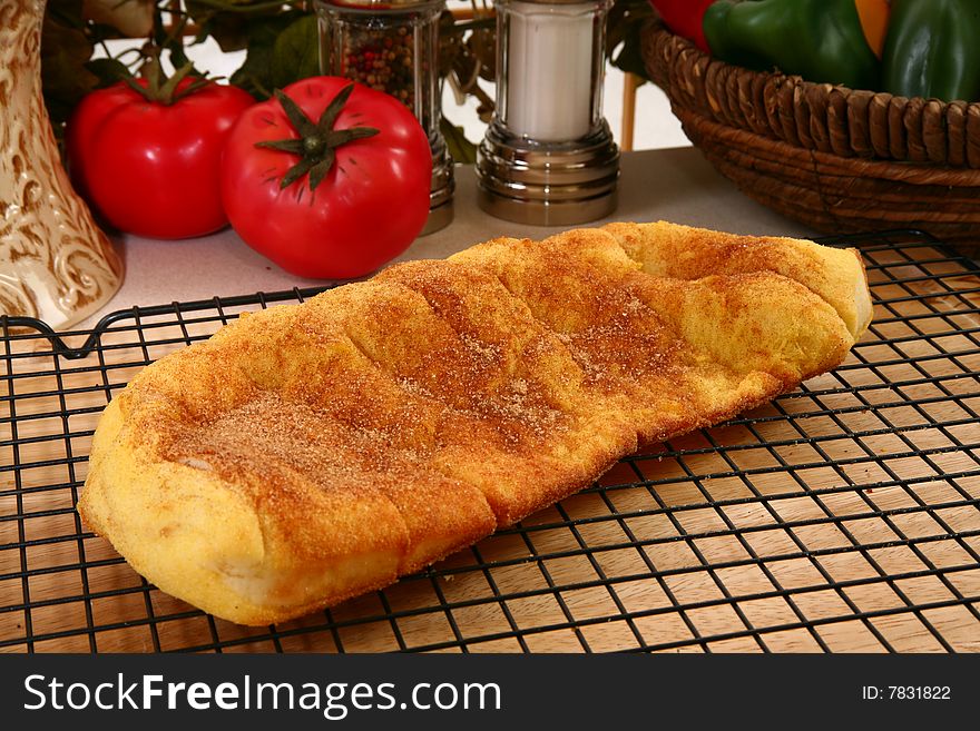 Close-up of a yummy golden brown flat loaf of sugary cinnamon bread. Close-up of a yummy golden brown flat loaf of sugary cinnamon bread.