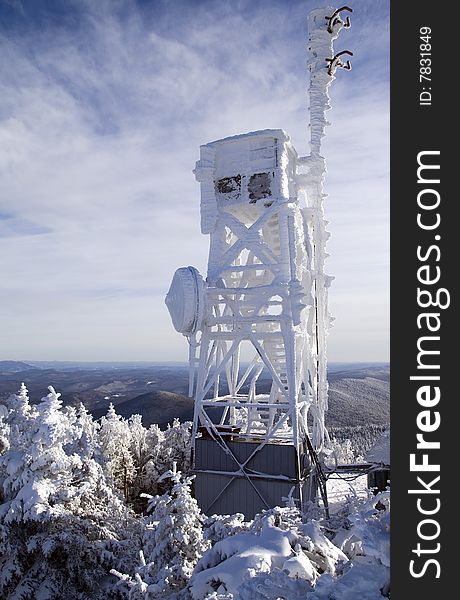 Telecommunication tower on the top of a mountain during the winter. Telecommunication tower on the top of a mountain during the winter