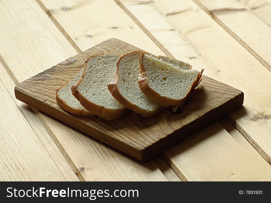 Slice bread on wooden plate