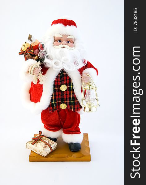 Toy Santa Claus, jolly, red suit, white beard and mustache, a bag with gifts