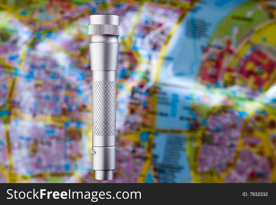 Light concept � flashlight over blurred map
