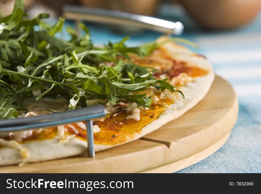 Detail of oven baked pizza served on wooden board