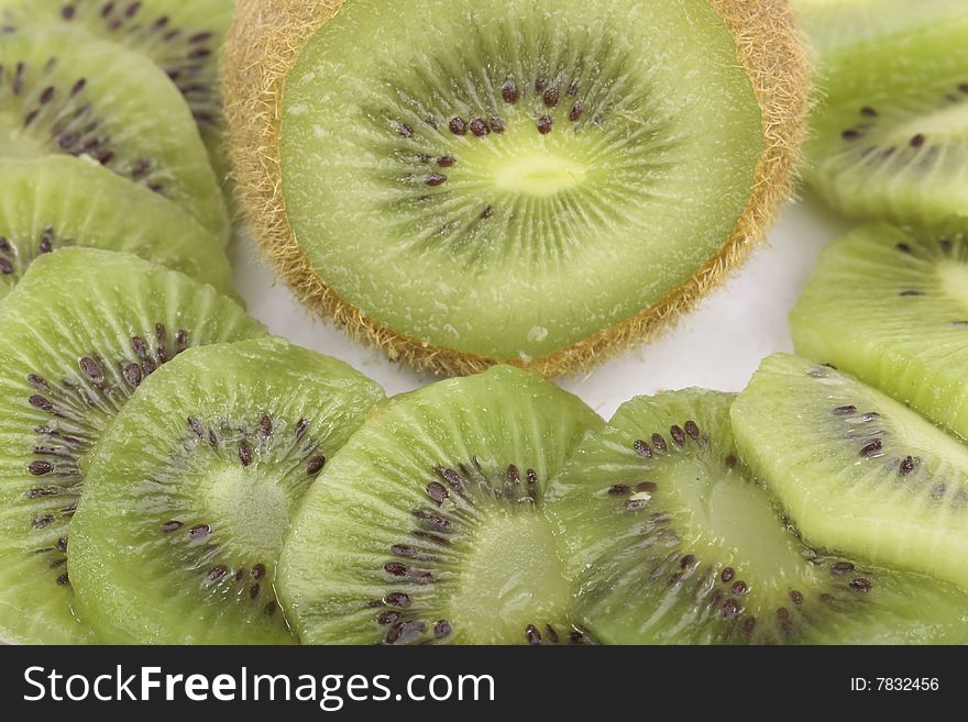 Kiwi fruit slices on saucer isolated on white background