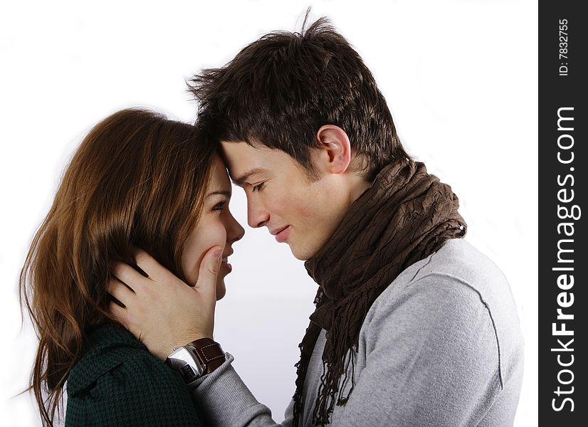 Young attractive couple looking into each other's eye isolated on white. Young attractive couple looking into each other's eye isolated on white