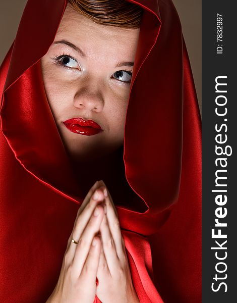 Close up portrait of attractive young woman in red hood