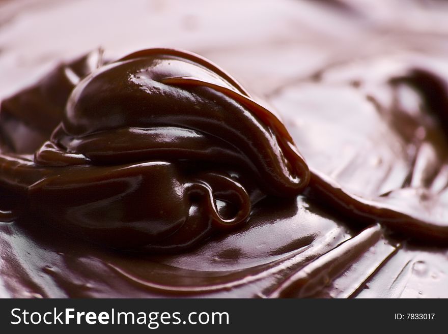 Macro of liquid chocolate making irresistible waves. Macro of liquid chocolate making irresistible waves.