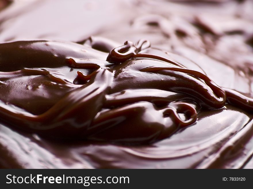 Macro of liquid chocolate making irresistible waves. Macro of liquid chocolate making irresistible waves.