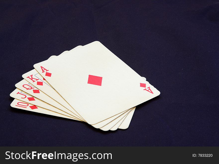 Poker hand showing a royal flush in diamonds on black background