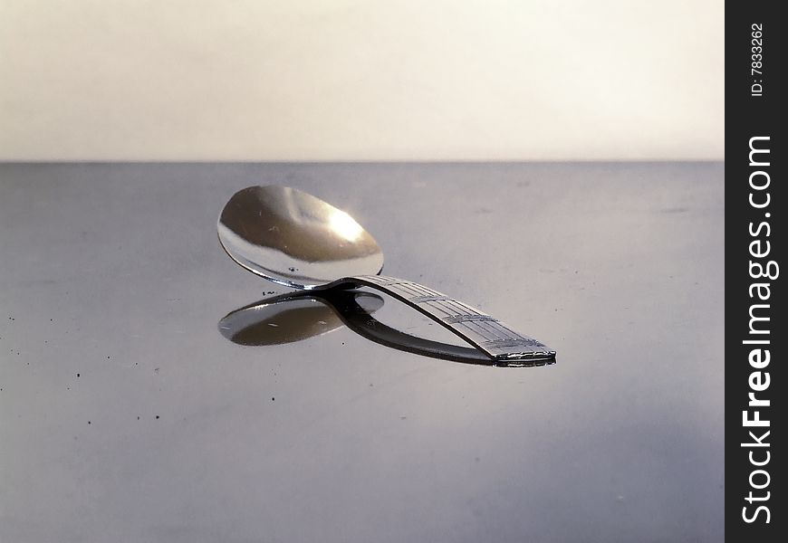Teaspoon on table with reflection. Teaspoon on table with reflection
