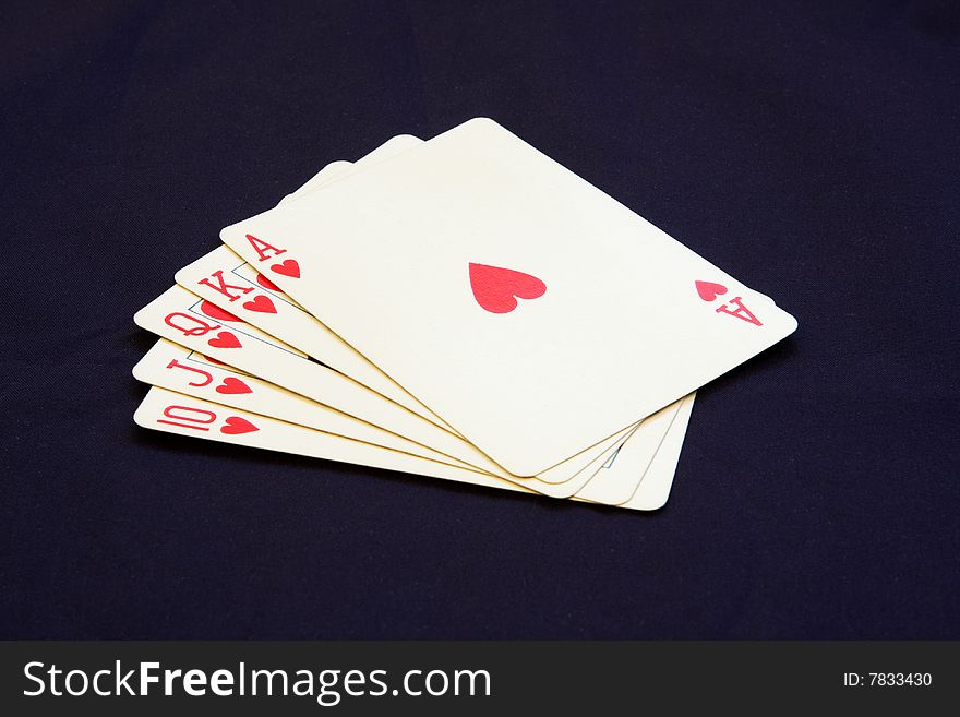Royal flush poker hand showing hearts on a black background. Royal flush poker hand showing hearts on a black background