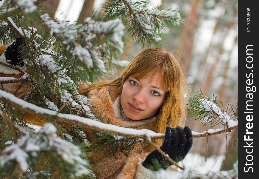 Red-heared girl in fur coat outdoors - shallow DOF. Red-heared girl in fur coat outdoors - shallow DOF