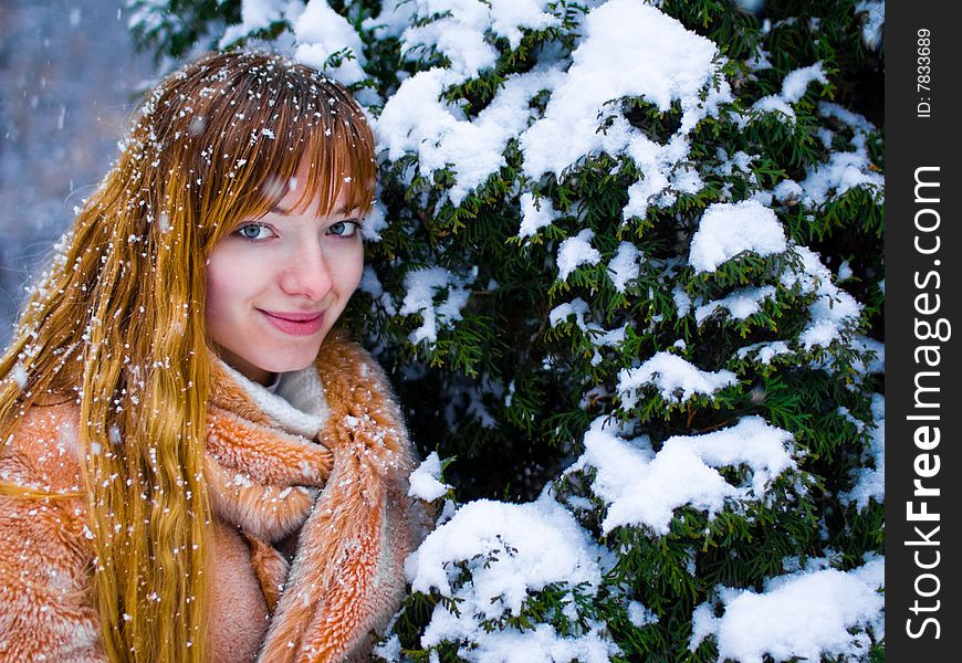 Red-heared girl in fur coat outdoors - shallow DOF. Red-heared girl in fur coat outdoors - shallow DOF