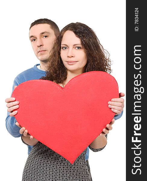 Loving couple holding big heart isolated over white