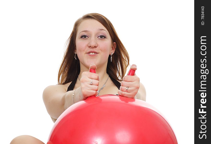 The girl has a good time with a red sphere is isolated on a white background. The girl has a good time with a red sphere is isolated on a white background