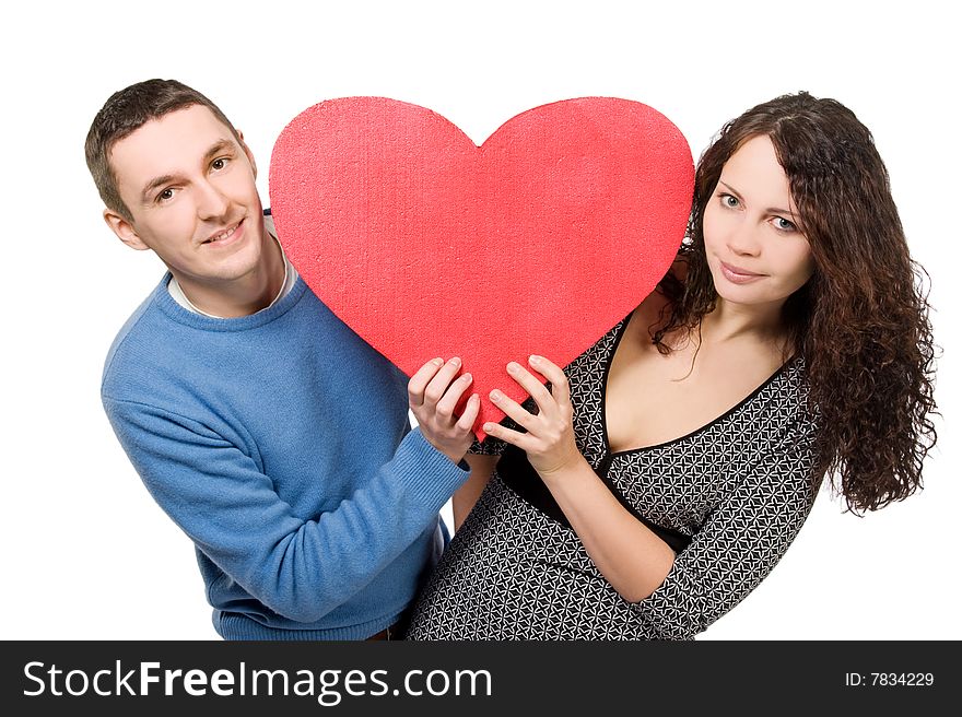 Happy loving couple with red heart isolated over white