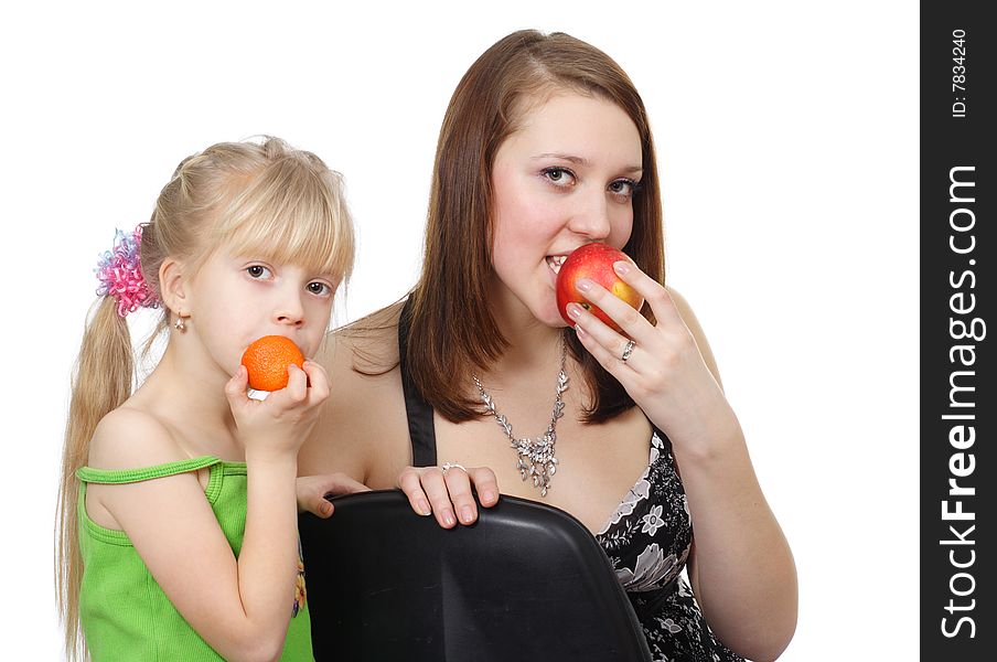 The child and  girl with fruit are isolated on a white background. The child and  girl with fruit are isolated on a white background