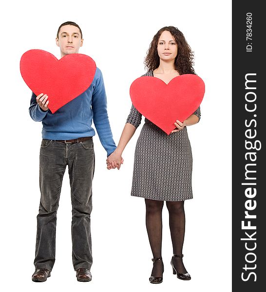 Couple holding two red hearts  isolated over white