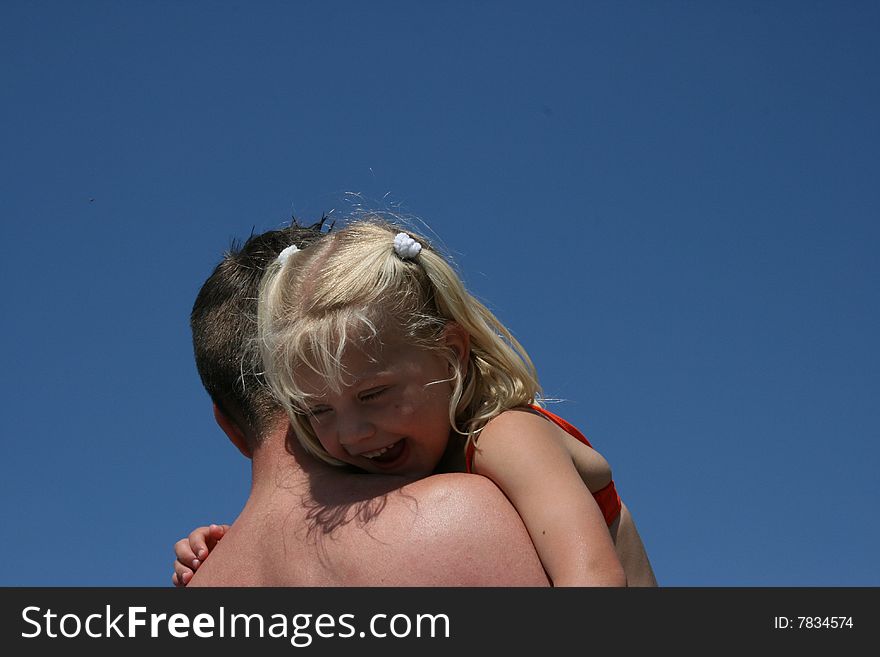 Laughing girl on the shoulder of a men