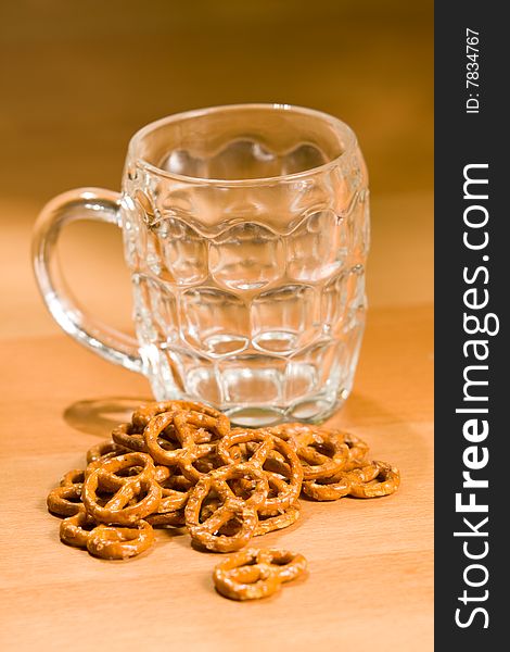 Empty beer glass with salty snacks. Empty beer glass with salty snacks