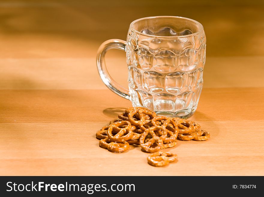 Empty beer glass with salty snacks. Empty beer glass with salty snacks