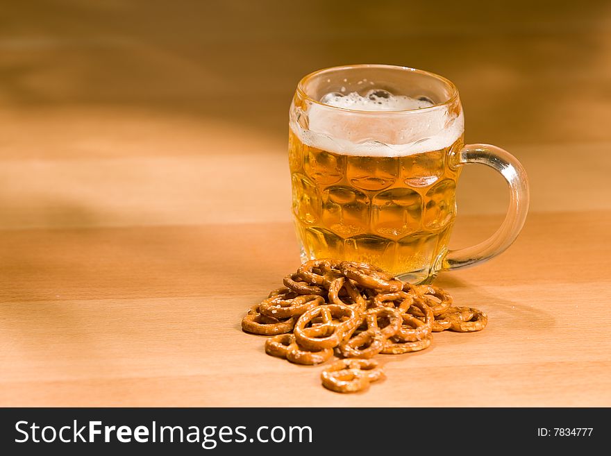 Glass of beer with salty snacs
