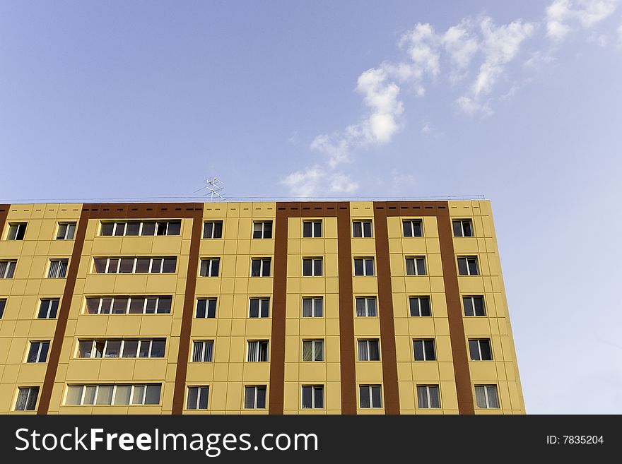 A background of a modern building in yellow and brown color, with furnishings of aluminum for windows. A background of a modern building in yellow and brown color, with furnishings of aluminum for windows.