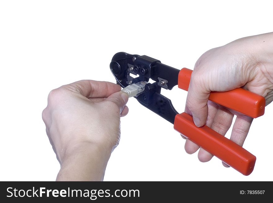 Woman hand keeps wire cable crimper on white background