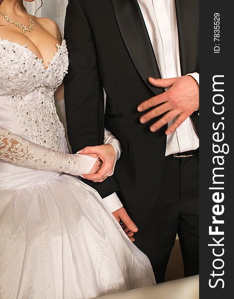 During a banquet the groom and the bride standing listen to congratulations. During a banquet the groom and the bride standing listen to congratulations.