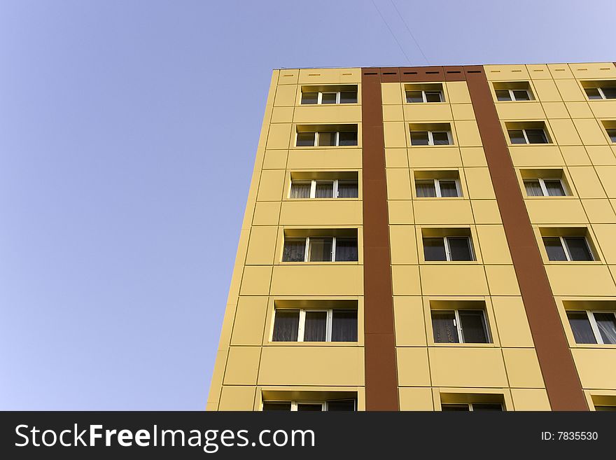 A background of a modern building in yellow and brown color, with furnishings of aluminum for windows. A background of a modern building in yellow and brown color, with furnishings of aluminum for windows.