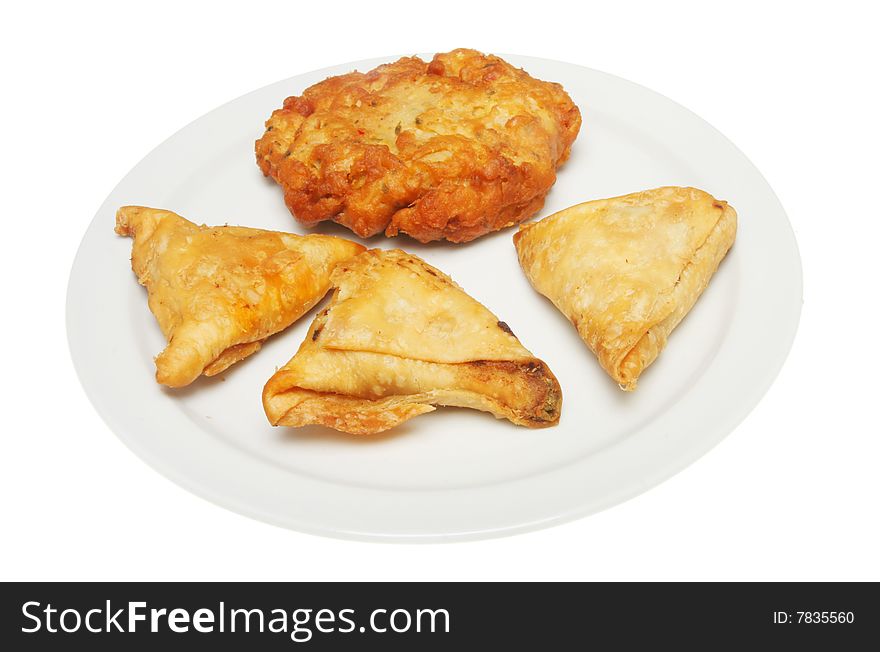 Samosa and onion bhajji on a plate. Samosa and onion bhajji on a plate