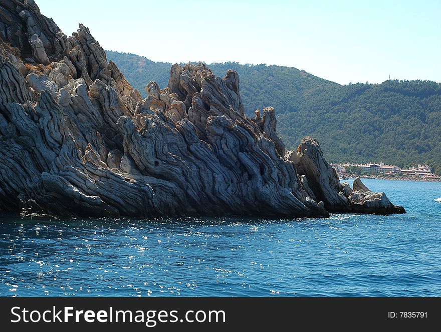 Stones rock on the blue sea and sky. Stones rock on the blue sea and sky