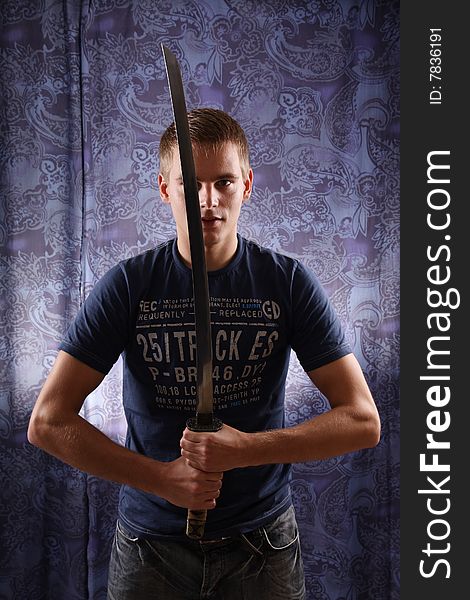 Studio portrait of young man and katana