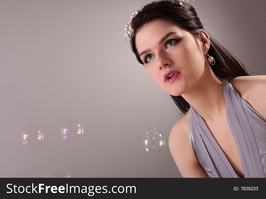Beautiful fashion model in studio and soap bubbles